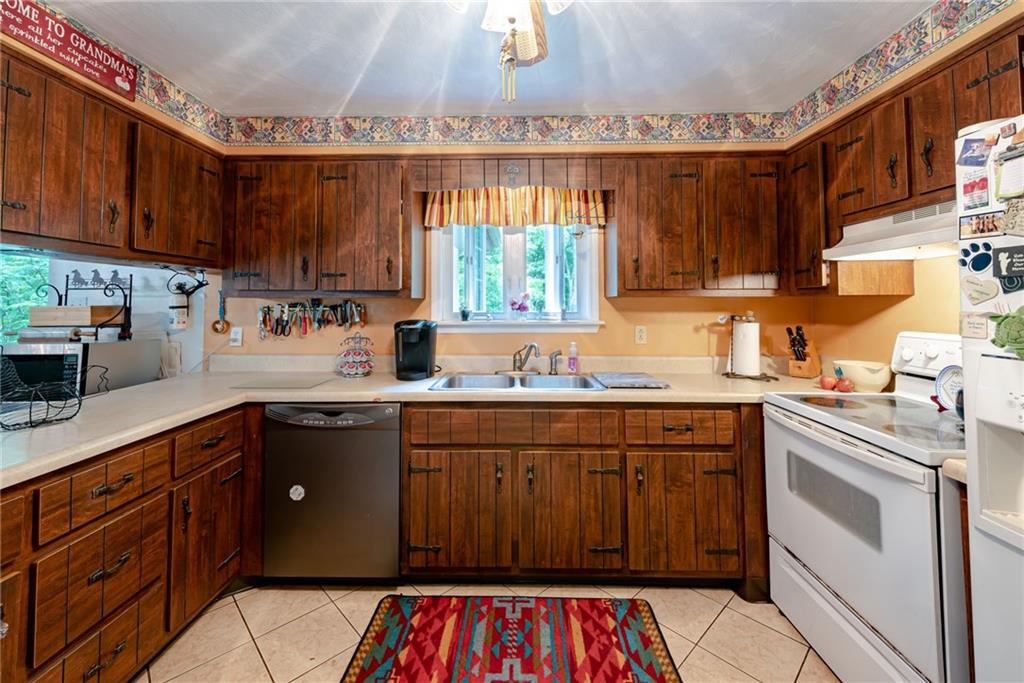 238 Greenbrier Road Acme, PA 15610 - Photo 5 of 15 a kitchen with a sink stove and cabinets