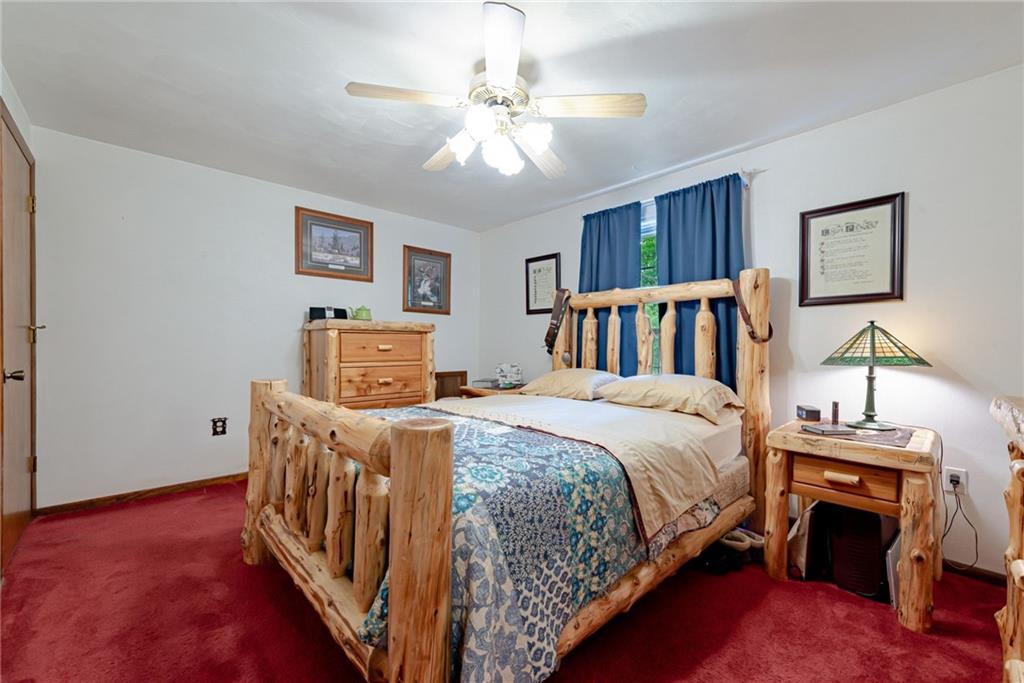 238 Greenbrier Road Acme, PA 15610 - Photo 7 of 15 a bed room with a bed and a chandelier