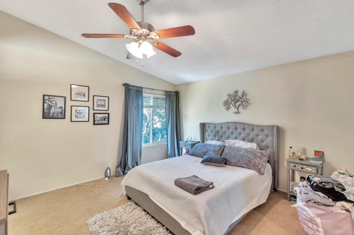 7400 Filice Drive Gilroy, CA 95020 - Photo 16 of 25 a bedroom with a large bed and a chandelier