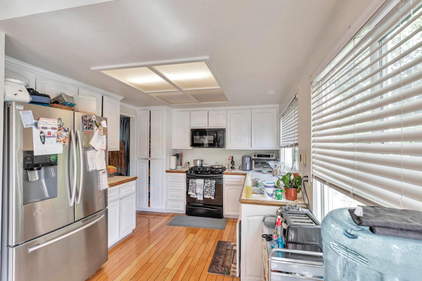 7400 Filice Drive Gilroy, CA 95020 - Photo 9 of 25 a kitchen with stainless steel appliances granite countertop a refrigerator and a stove top oven
