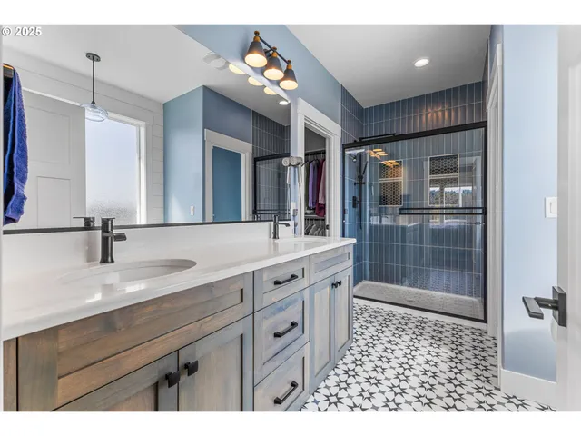 a bathroom with a sink a vanity a mirror and shower