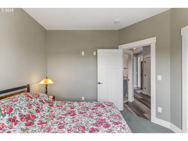 a bedroom with a bed and a lamp