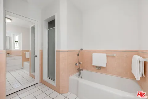 a bathroom with a bathtub and a shower