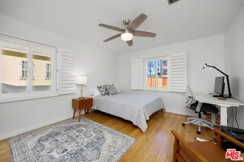 a bedroom with a bed and wooden floor
