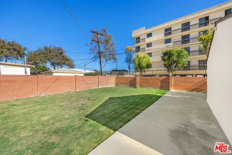 a view of a garden with a building in the background