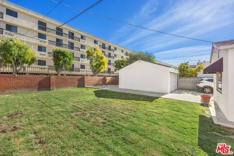 a backyard of a house with yard and outdoor seating