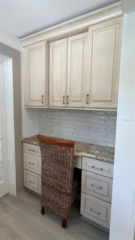 a kitchen with granite countertop white cabinets and sink