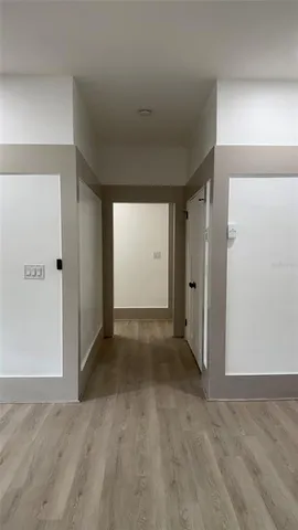 an empty room with closet and wooden floor