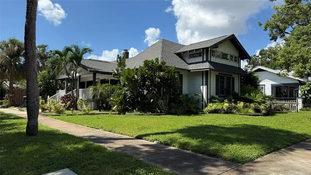 a view of a house with a yard and plants