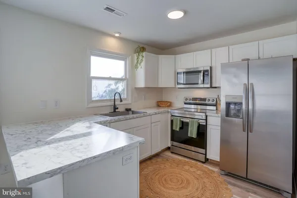 a kitchen with a sink stove and refrigerator