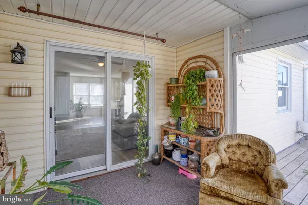 a balcony with furniture and a potted plant