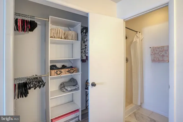 a bathroom with a granite countertop sink toilet and mirror