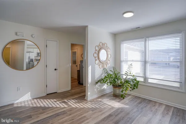 a large kitchen with a large window and stainless steel appliances