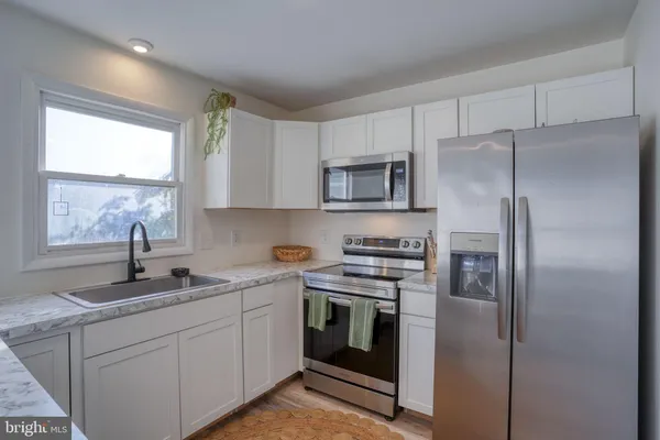 a kitchen with a refrigerator and a sink