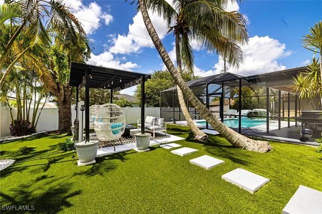 a view of a backyard with swimming pool