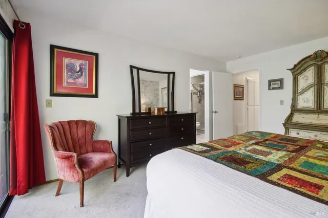 a bedroom with a bed and chair