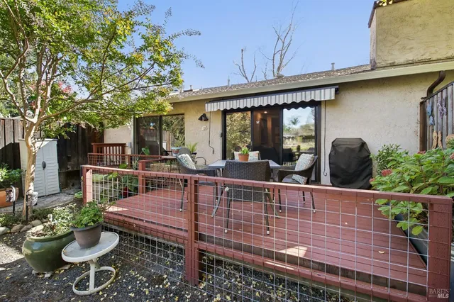 a view of a patio with couches table and chairs and potted plants
