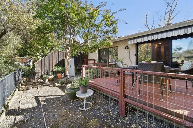 a view of a house with backyard sitting area and garden
