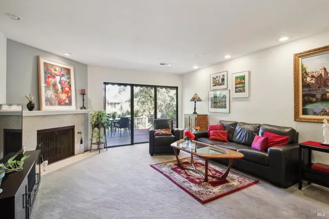 a living room with furniture a window and a fireplace