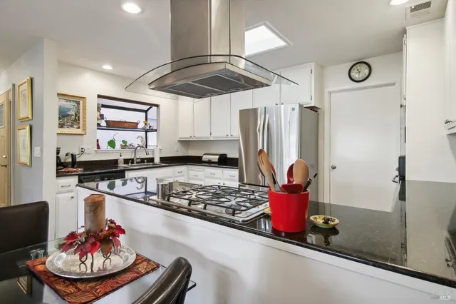 a kitchen with stainless steel appliances granite countertop a sink and cabinets