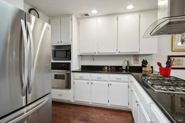 a kitchen with stainless steel appliances a refrigerator sink and stove