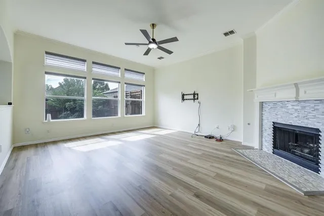 a view of empty room with wooden floor and fireplace
