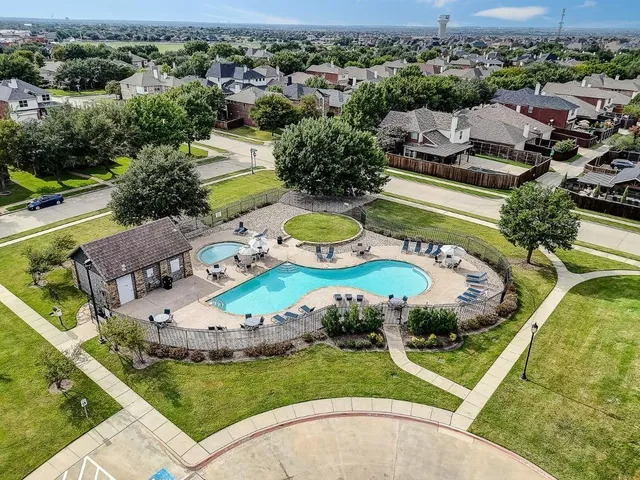 an aerial view of a house with garden space and lake view