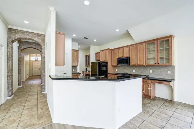 a kitchen with stainless steel appliances granite countertop a sink and cabinets