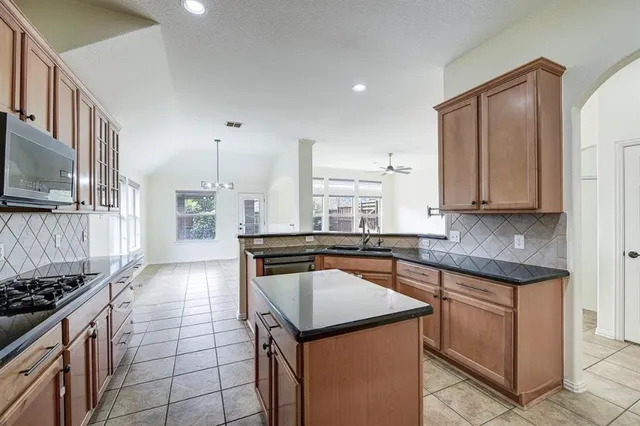 a kitchen with a stove a sink and a refrigerator