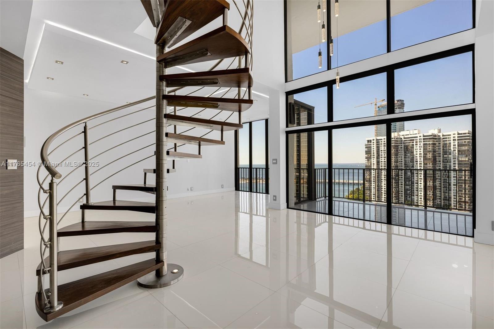1925 Brickell Avenue, Unit DPH7 Miami, FL 33129 - Photo 1 of 45 a view of staircase with lots of frames on wall