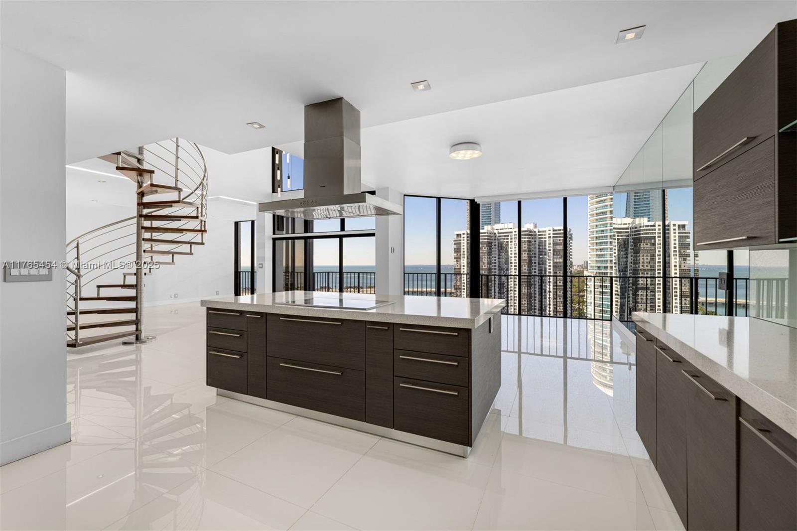 1925 Brickell Avenue, Unit DPH7 Miami, FL 33129 - Photo 21 of 45 a large kitchen with granite countertop a sink and dishwasher a stove top oven with wooden floor