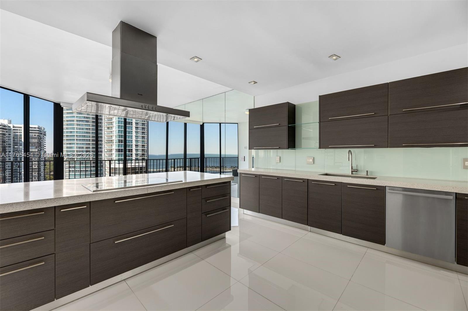 1925 Brickell Avenue, Unit DPH7 Miami, FL 33129 - Photo 22 of 45 a large kitchen with granite countertop a sink and a stove top oven