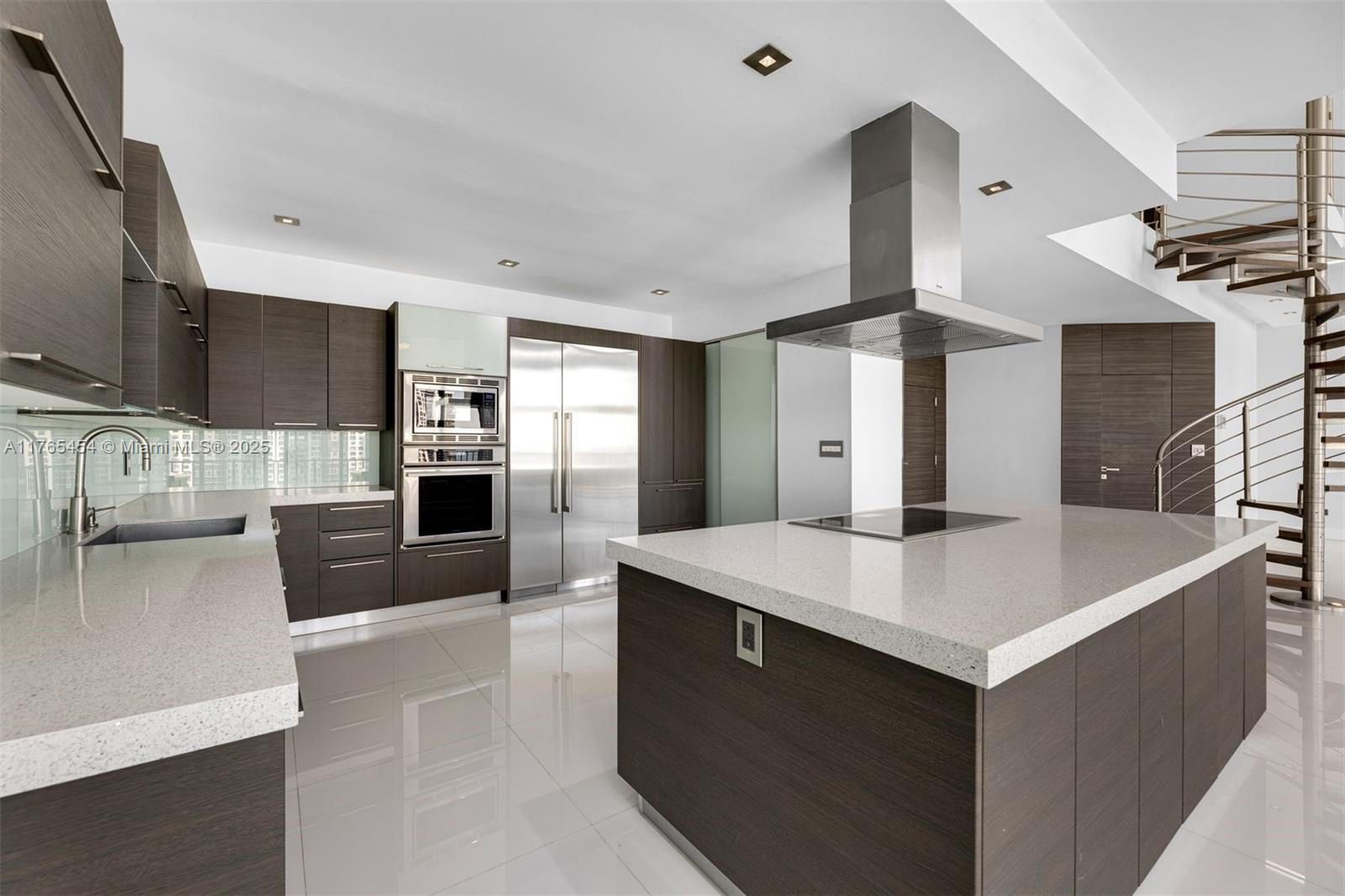 1925 Brickell Avenue, Unit DPH7 Miami, FL 33129 - Photo 23 of 45 a kitchen with stainless steel appliances a sink and a refrigerator
