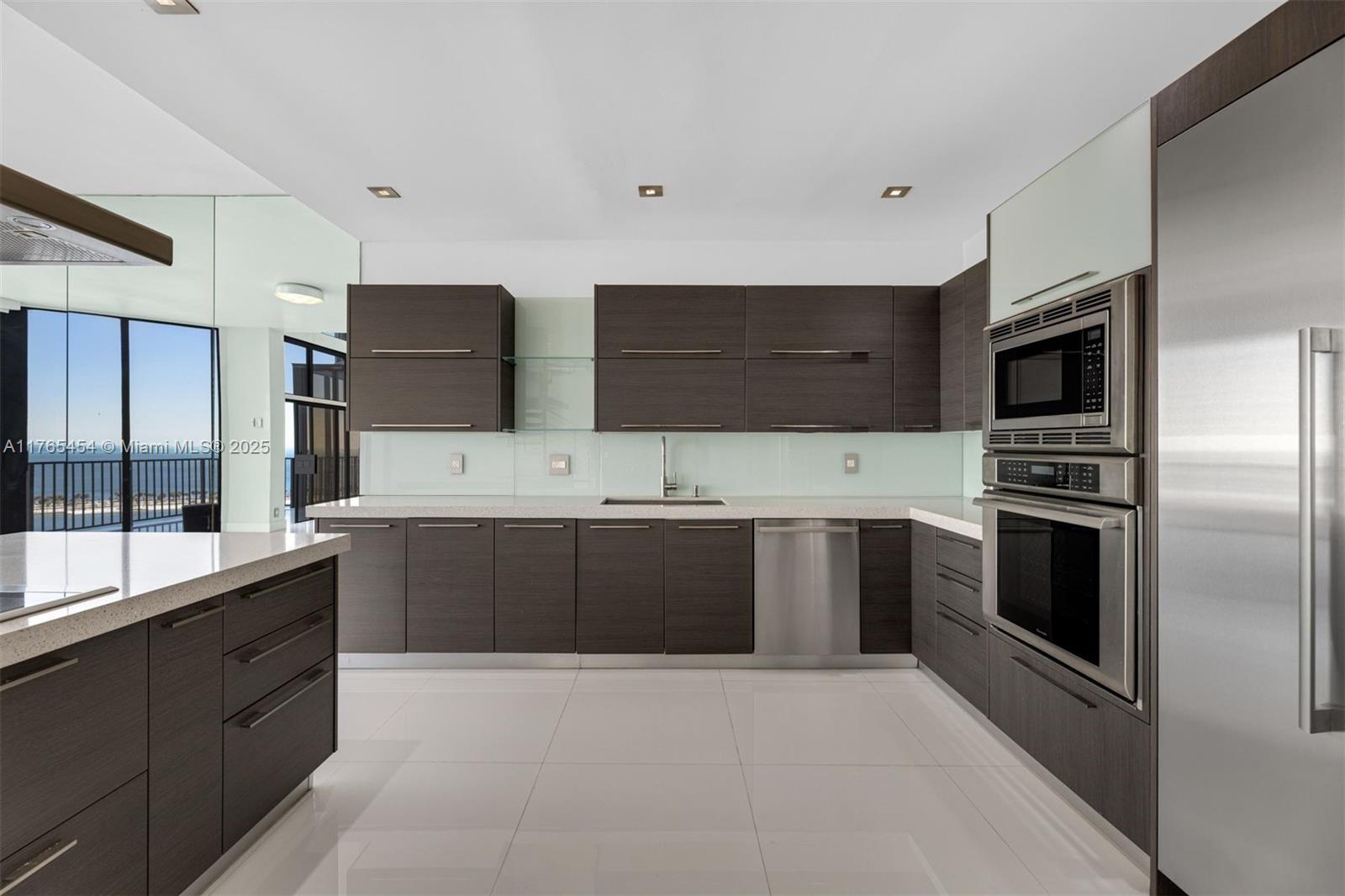 1925 Brickell Avenue, Unit DPH7 Miami, FL 33129 - Photo 25 of 45 a large kitchen with a large counter top stainless steel appliances and cabinets