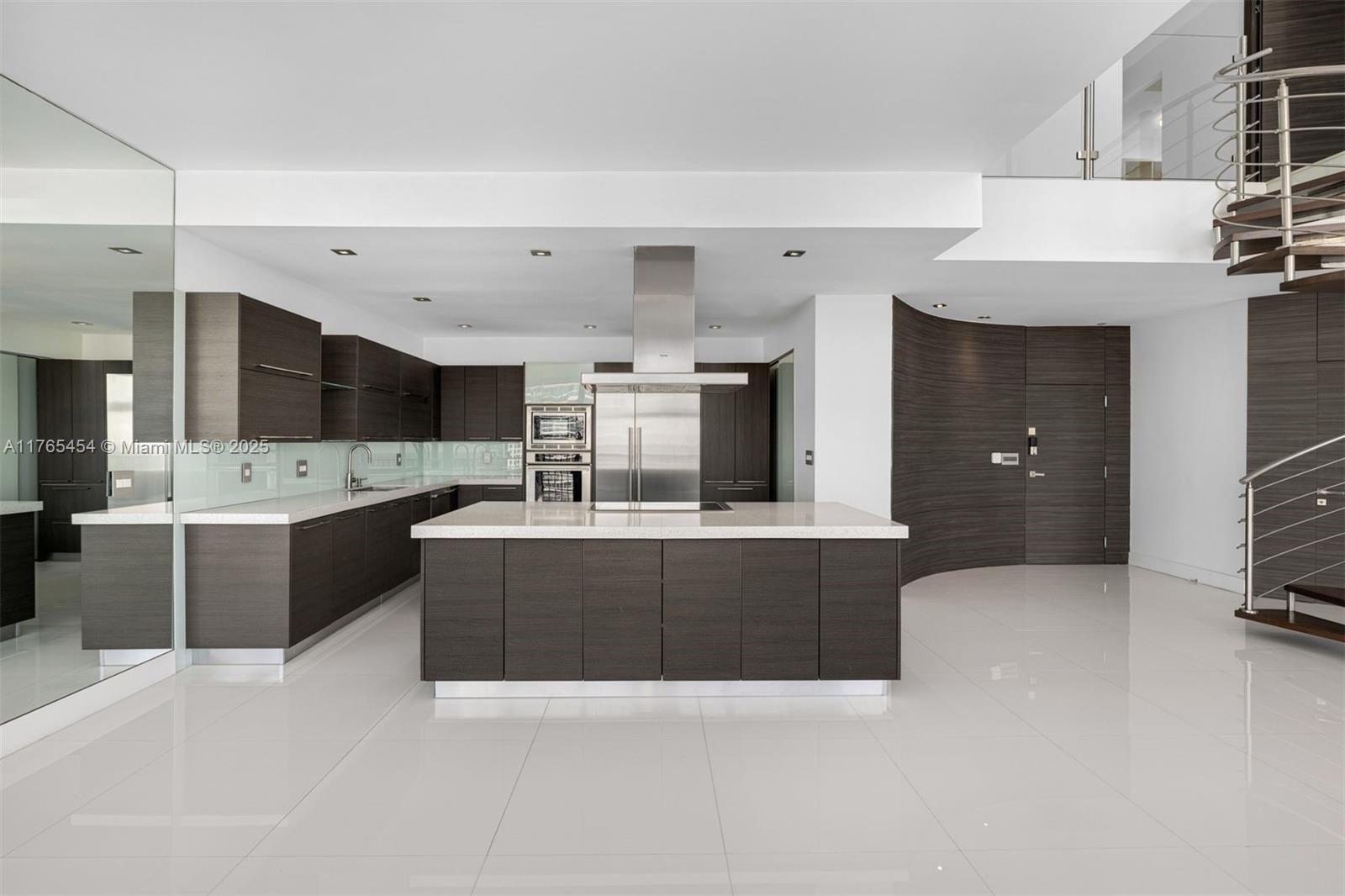 1925 Brickell Avenue, Unit DPH7 Miami, FL 33129 - Photo 27 of 45 a large white kitchen with stainless steel appliances