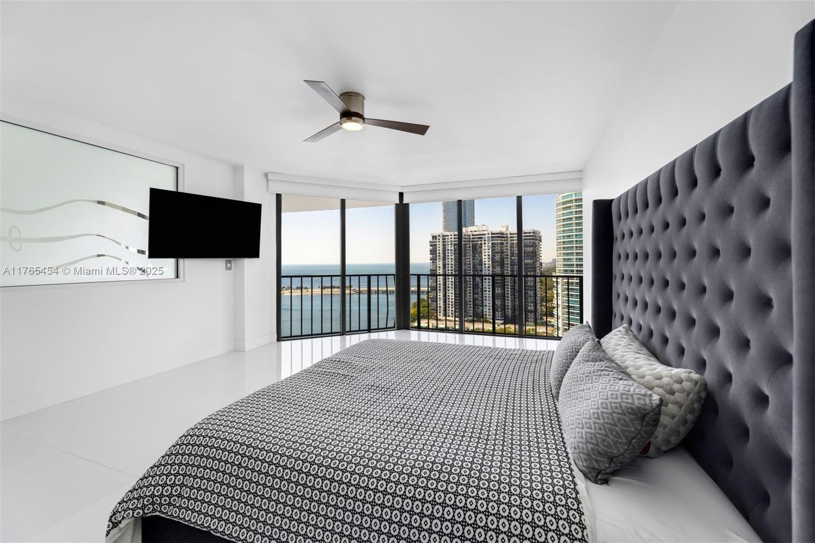 1925 Brickell Avenue, Unit DPH7 Miami, FL 33129 - Photo 31 of 45 a bedroom with a bed tv and a window