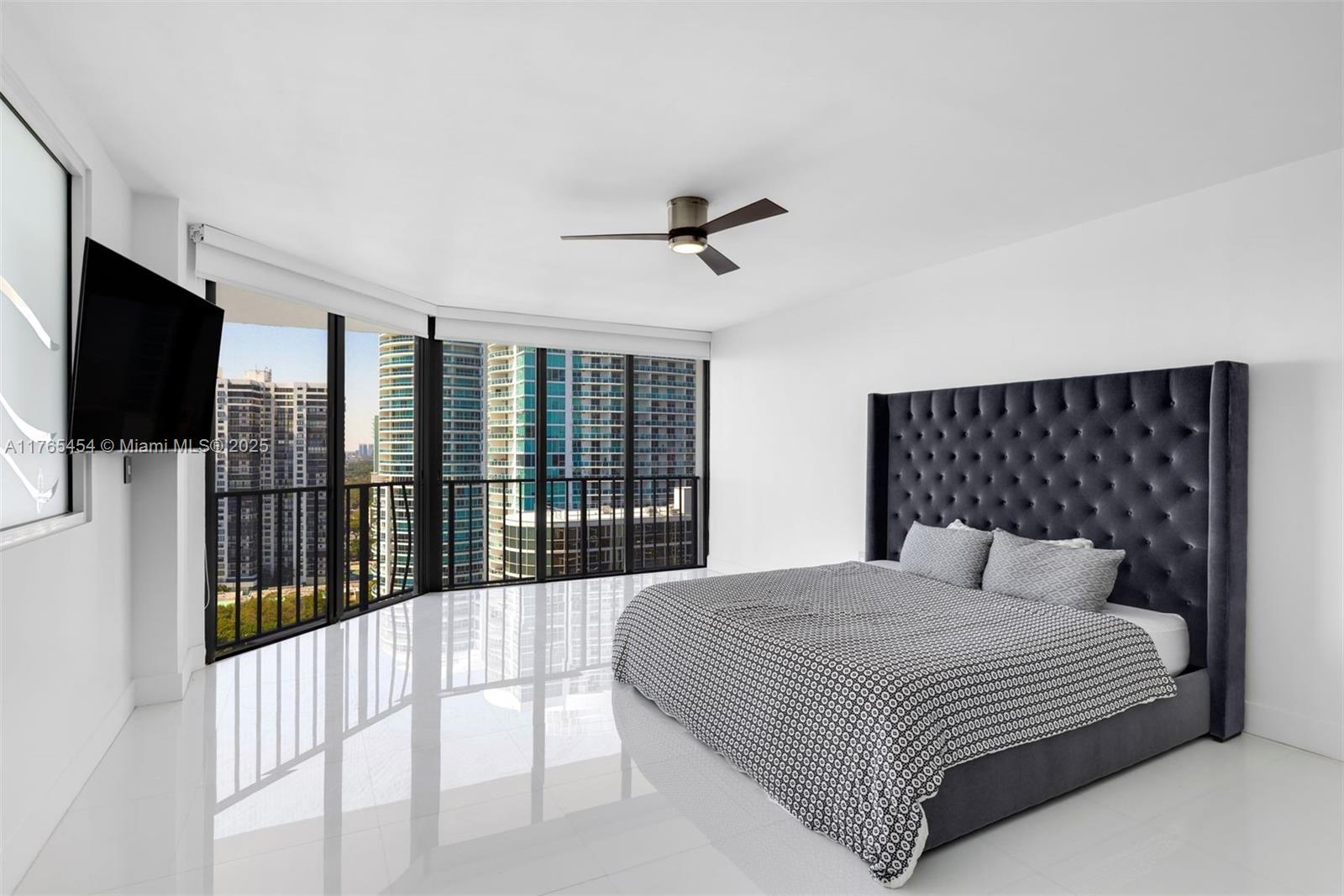 1925 Brickell Avenue, Unit DPH7 Miami, FL 33129 - Photo 33 of 45 a bedroom with a balcony a bed and a flat tv screen