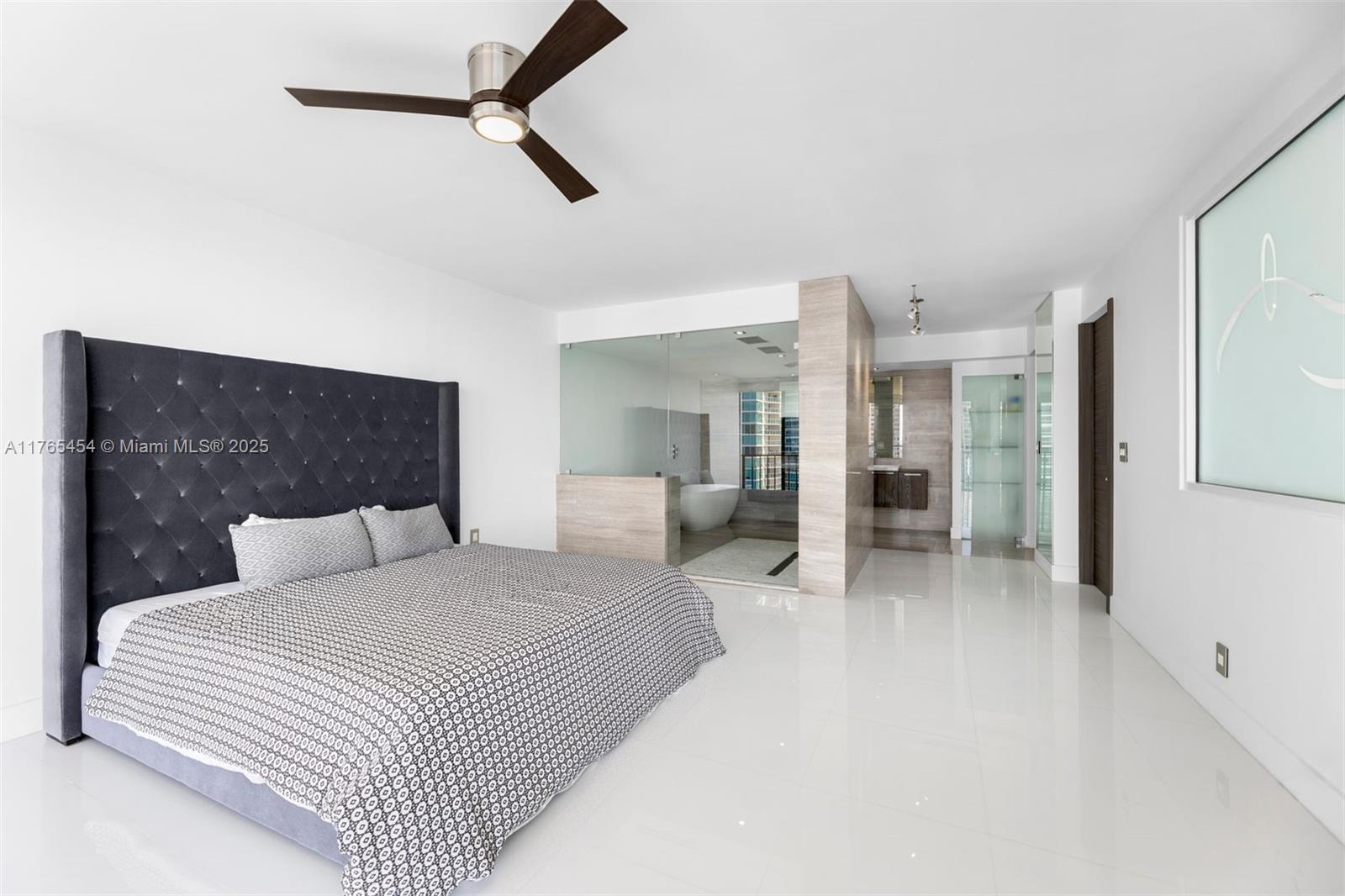 1925 Brickell Avenue, Unit DPH7 Miami, FL 33129 - Photo 34 of 45 a bedroom with a large bed and a chandelier