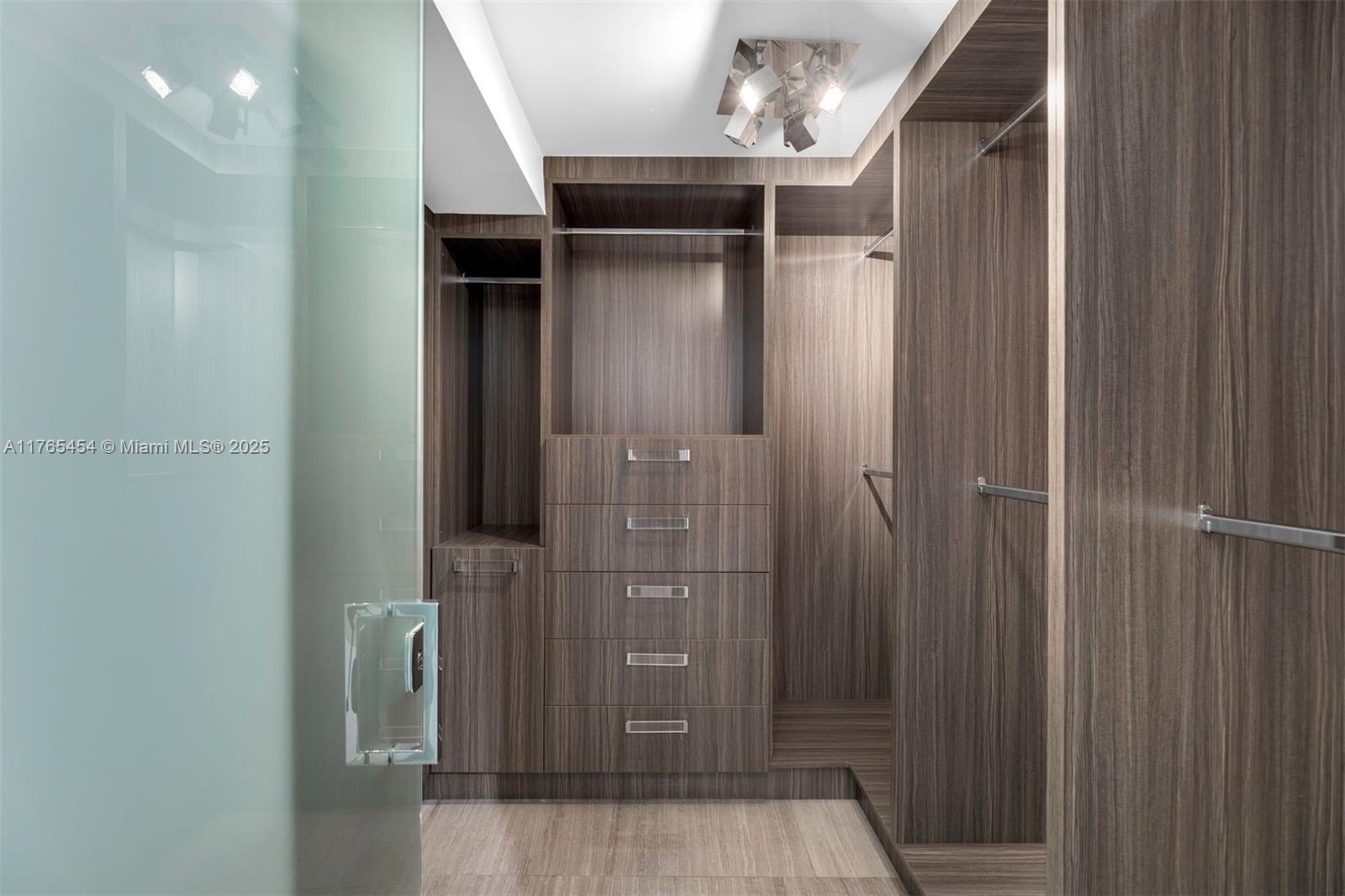 1925 Brickell Avenue, Unit DPH7 Miami, FL 33129 - Photo 37 of 45 a view of a hallway with wooden cabinets