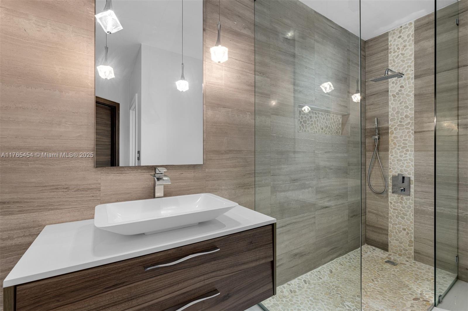 1925 Brickell Avenue, Unit DPH7 Miami, FL 33129 - Photo 39 of 45 a bathroom with a sink shower and a mirror