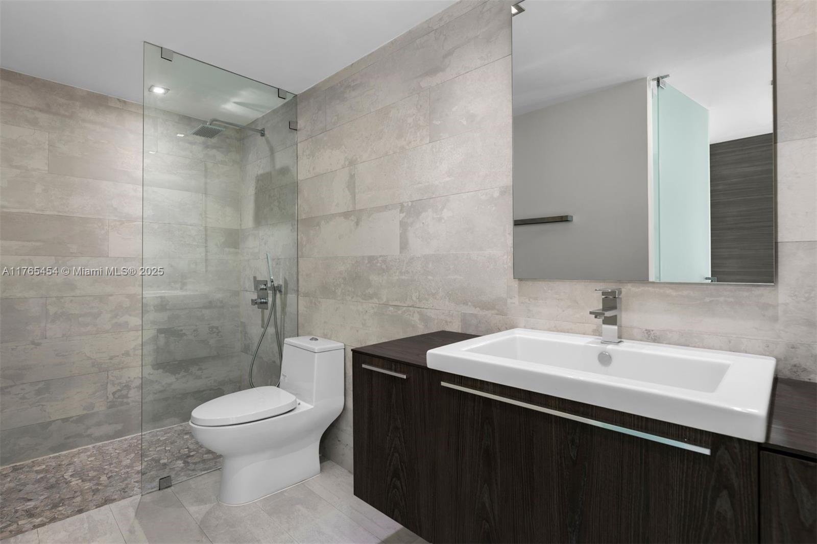 1925 Brickell Avenue, Unit DPH7 Miami, FL 33129 - Photo 41 of 45 a bathroom with a sink a toilet and shower