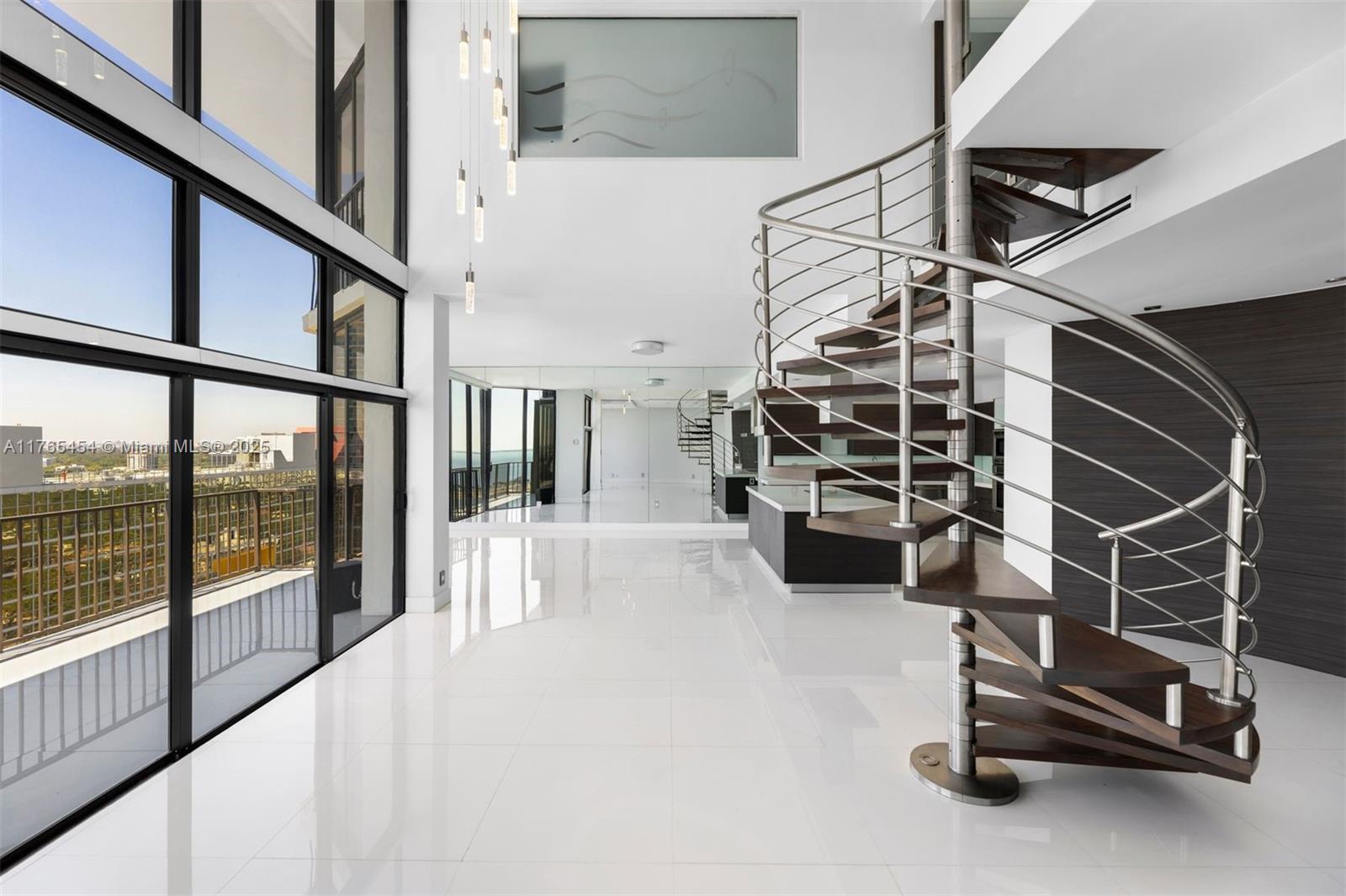1925 Brickell Avenue, Unit DPH7 Miami, FL 33129 - Photo 9 of 45 a view of an empty room with stairs