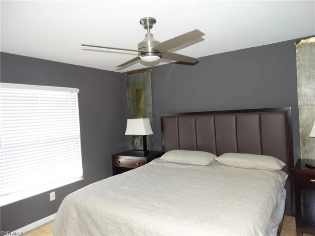 a bedroom with a bed and a lamp