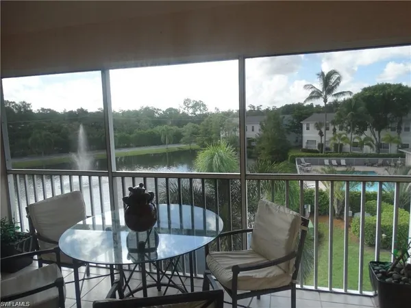 a view of a balcony with a table and chairs