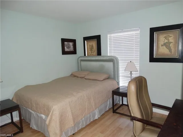 a bedroom with a bed and a chair