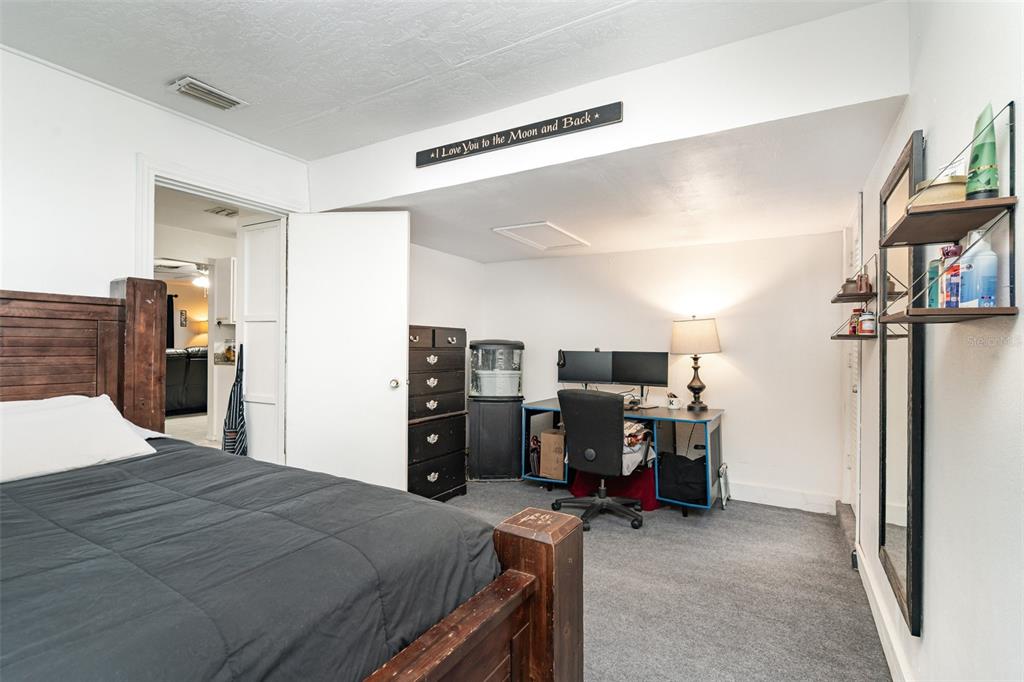 1107 Cable Lane Northeast Palm Bay, FL 32905 - Photo 11 of 17 a bedroom with a bed and furniture