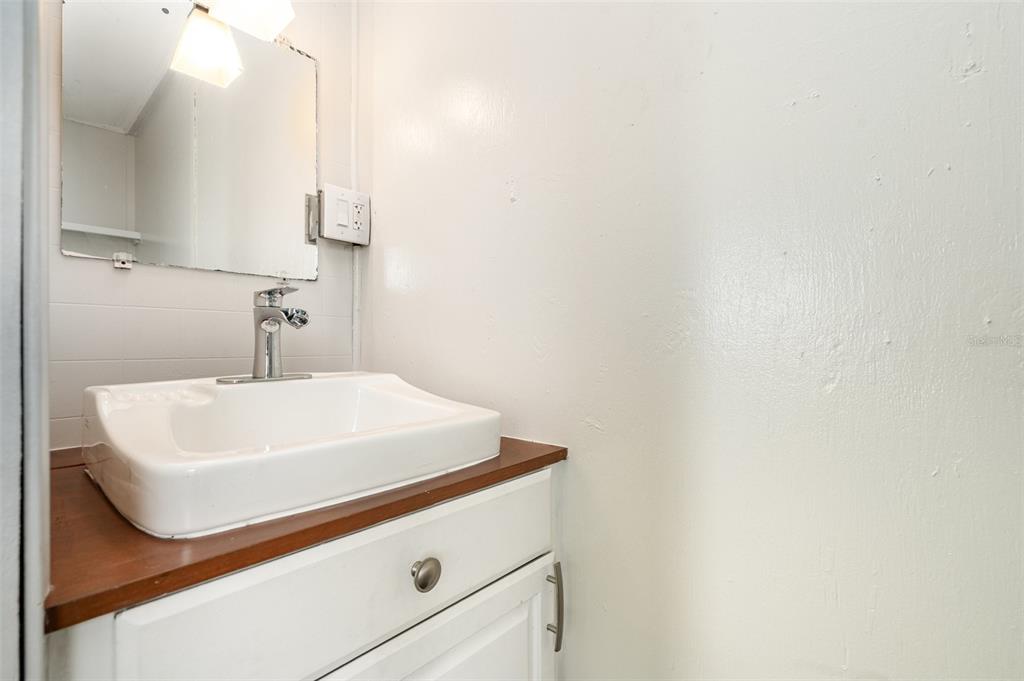 1107 Cable Lane Northeast Palm Bay, FL 32905 - Photo 5 of 17 a bathroom with a sink and a mirror