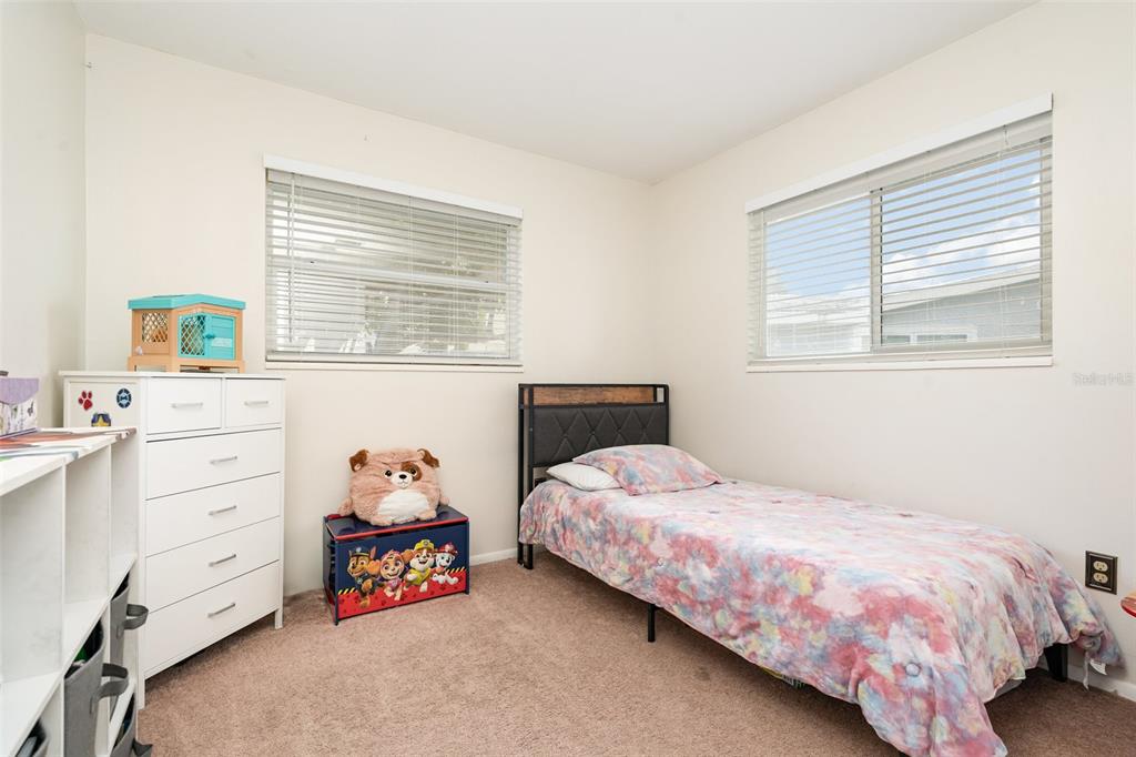 1107 Cable Lane Northeast Palm Bay, FL 32905 - Photo 8 of 17 a bedroom with a bed and a dresser