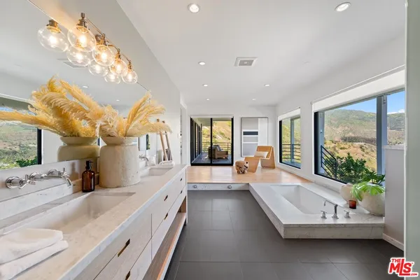 a large white kitchen with a large window