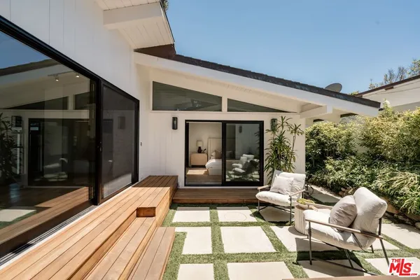 a balcony with furniture and wooden floor